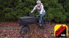 Anne-Marije Rook with her Omnium cargo bike, wearing Specialized's Packable Down Jacket