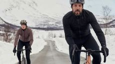 Male and Female riding in the snow wearing Velocio clothing